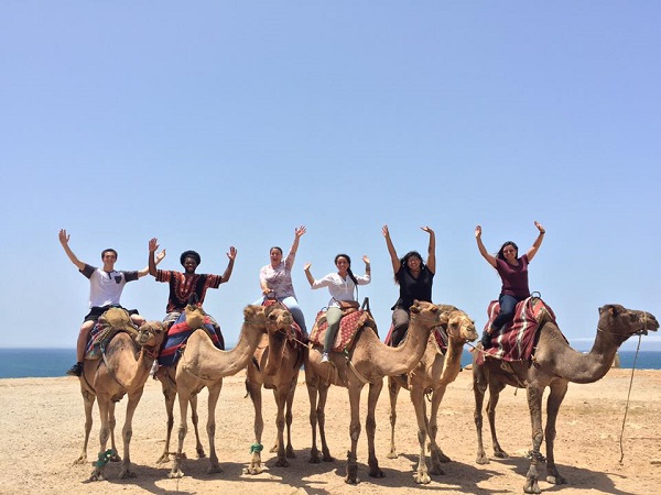 students on camels on first gen abroad trip