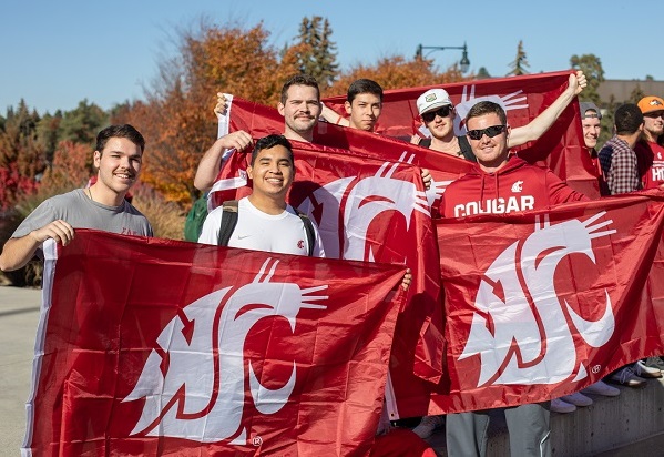 students holding flags with WSU logo